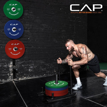 CAP barbell set with green, blue and red weight plates on stand, durable steel gym equipment