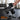 Black 300 lb barbell weight set with rubber plates on a sturdy rack in gym