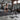 Black power rack in gym with weight plates and barbell bench, steel fitness equipment